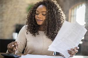 woman doing calculations with calculator