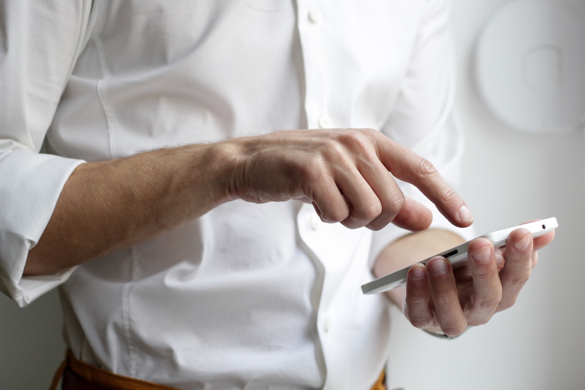 a man typing into a phone