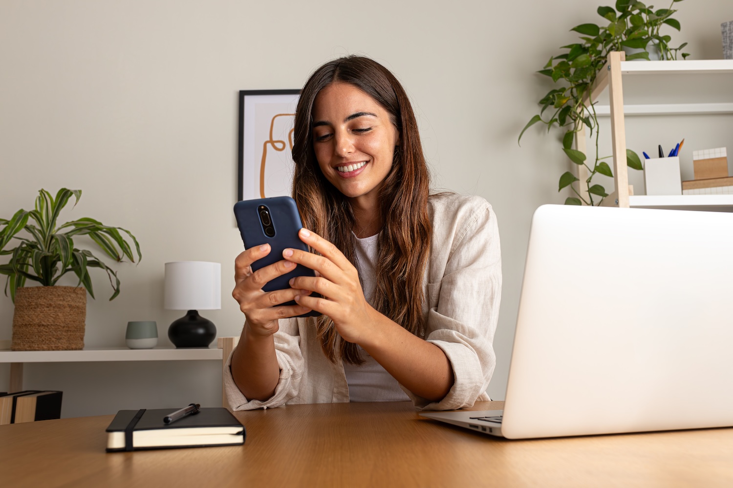 woman on phone and laptop