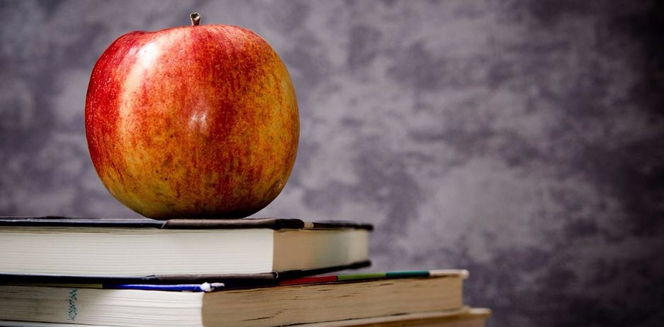 apple on top of textbooks