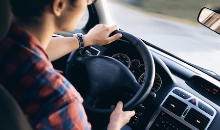 A driver sitting in their car.