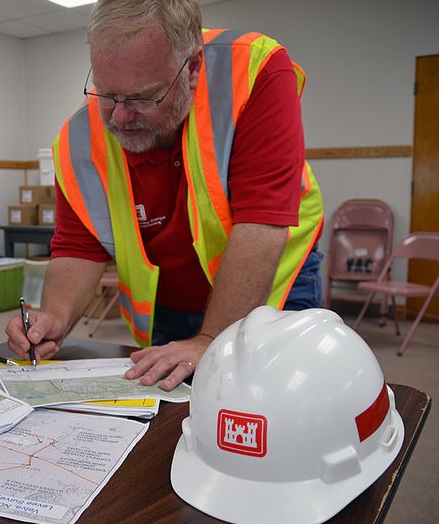 Lt. Col. Kendall Bergmann, U.S. Army Corps of Engineers St. Paul District deputy engineer, and Roland Hamborg, St. Paul District Souris River sub-sub area engineer, discuss temporary levee construction plans her