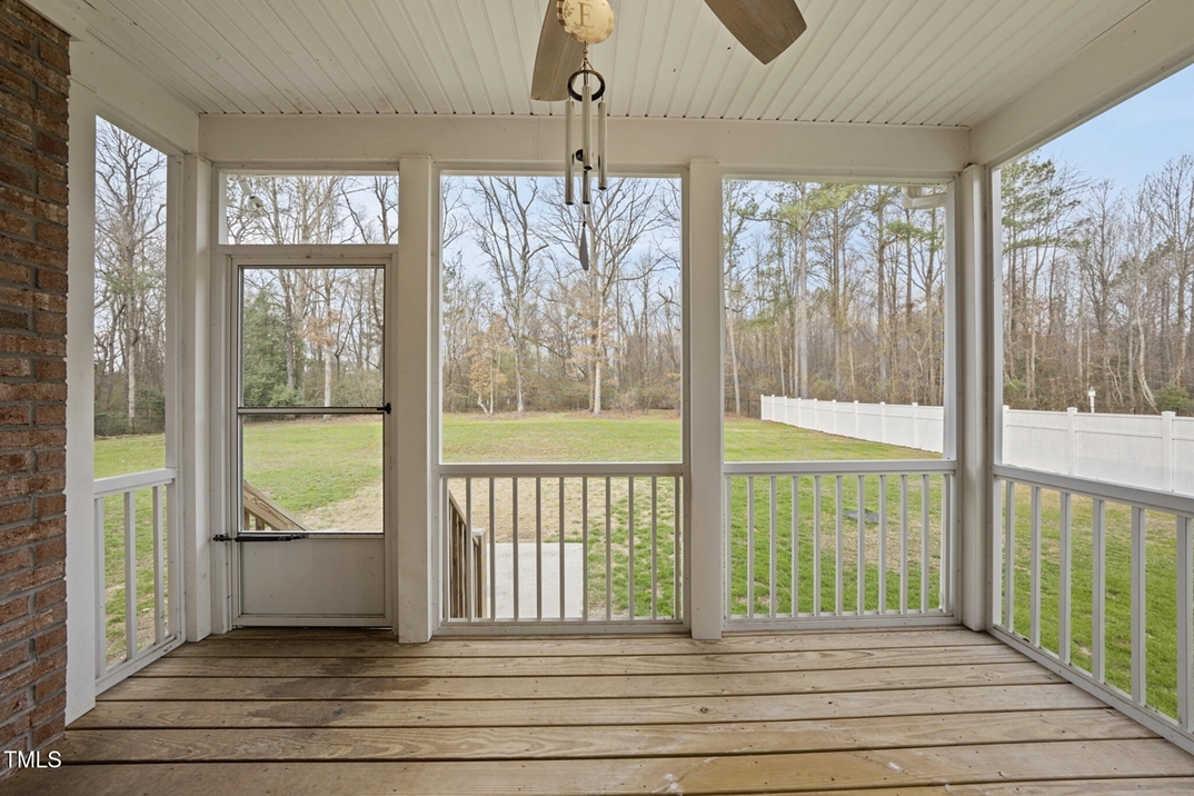 Screened porch with wooded views in The Landing At Cooper Fields in Nashville NC