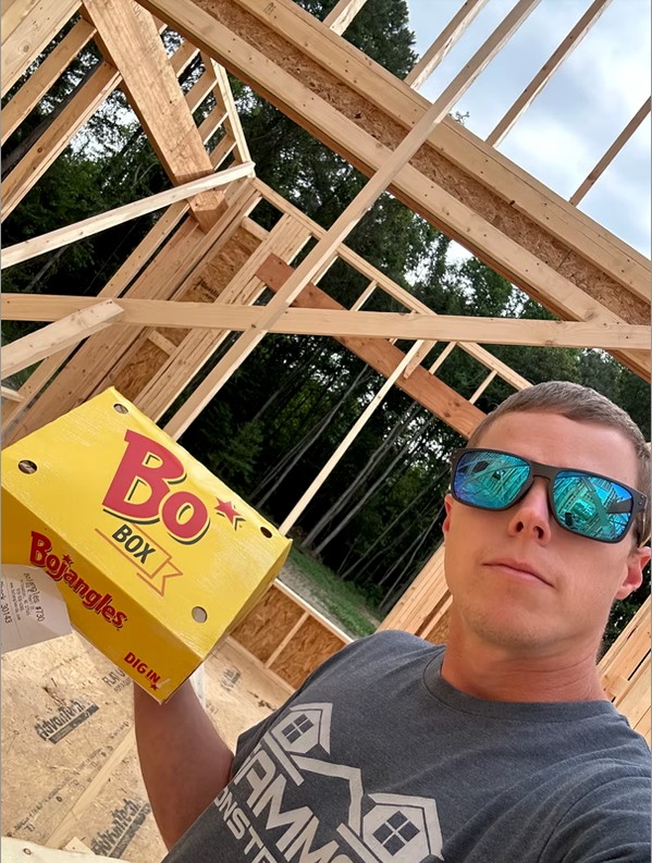 holding bojangles box in construction site