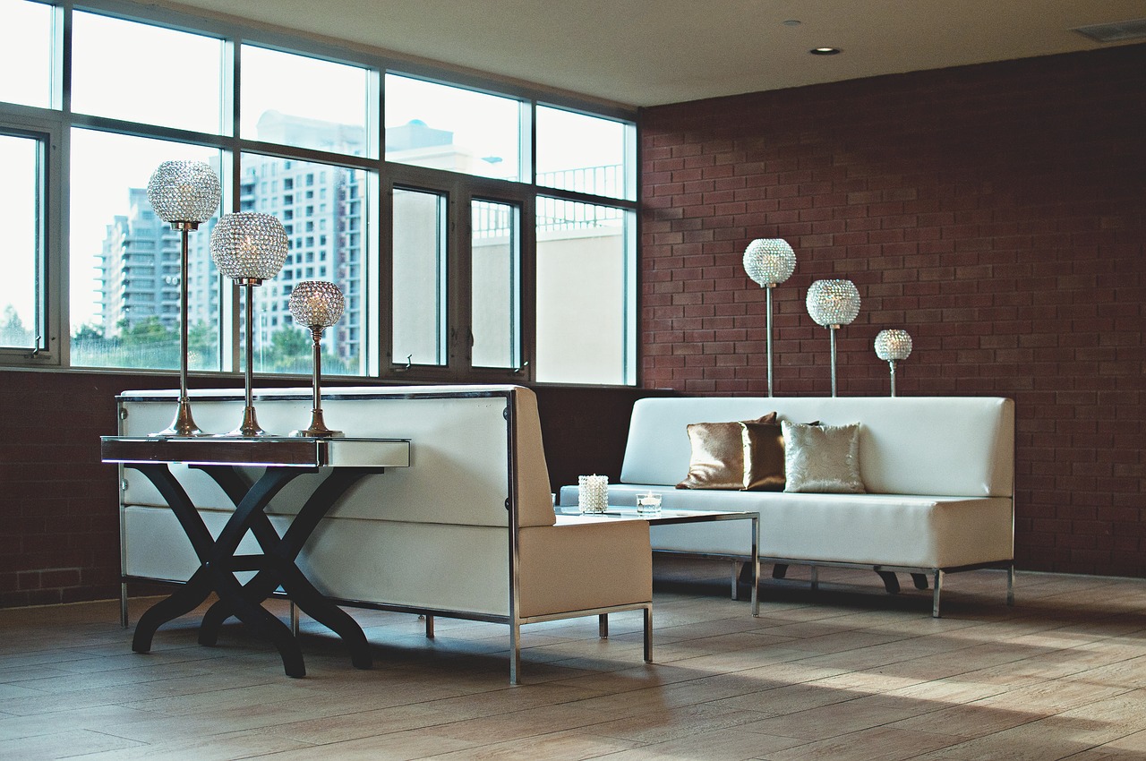 Apartment building interior with fancy white couches.