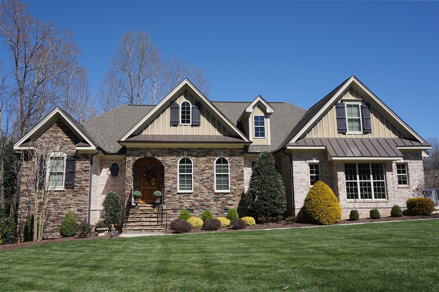 Two-story charcoal gray home.
