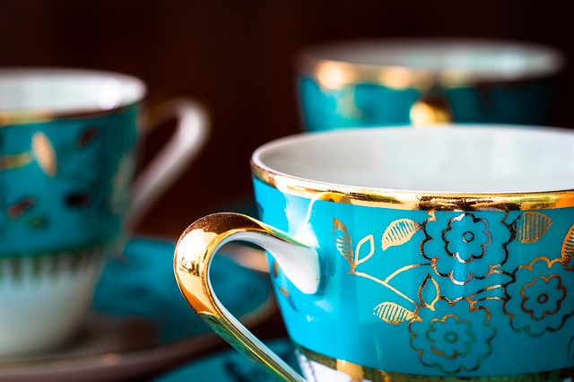 Three blue and gold vintage teacups at an antique shop.