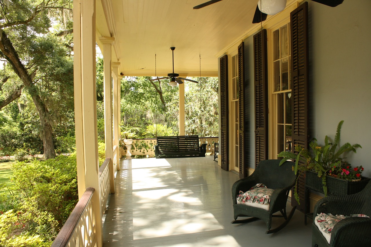 front porch with green wicker rocking chair