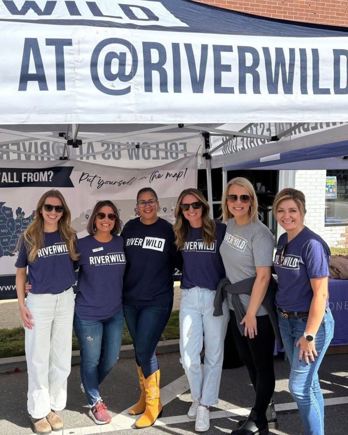 Six RiverWILD team members beneath the branded tent at the Clayton Harvest Festival