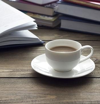 novel and a hot cup of coffee