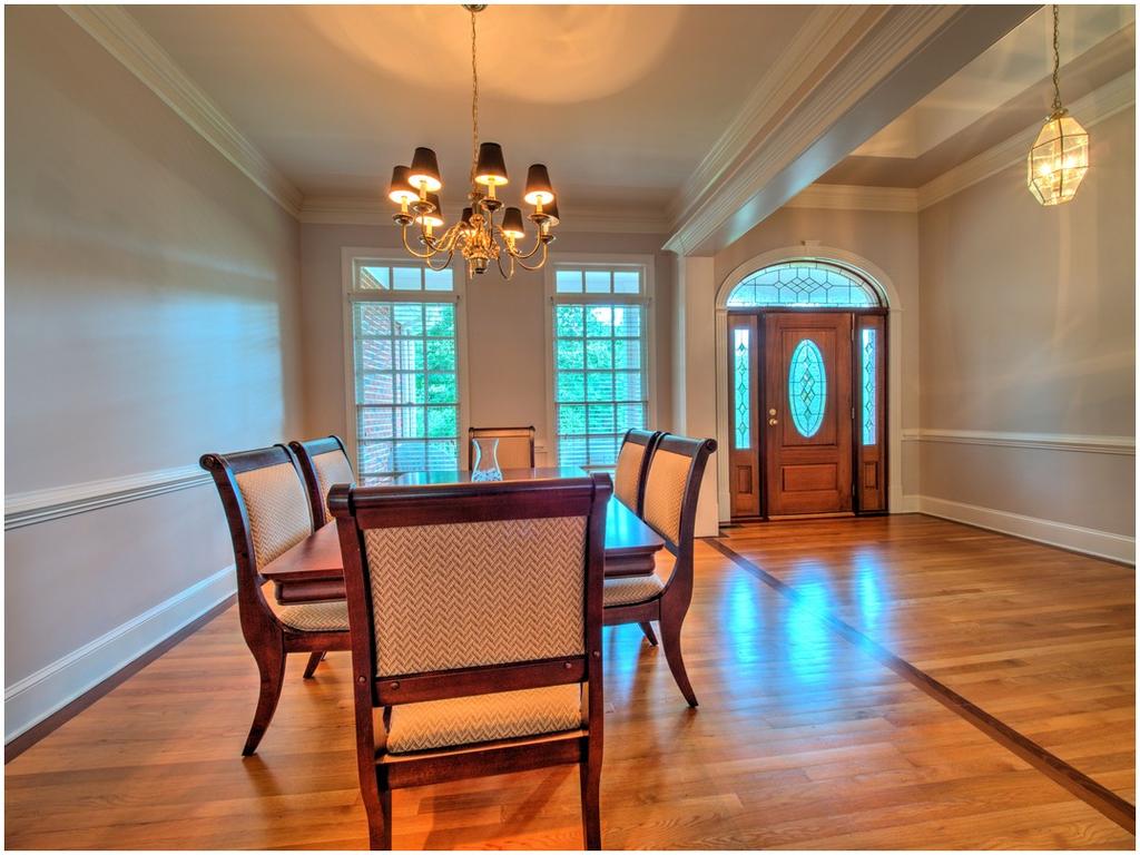 Inviting Dining Room with Chair Rail Adjacent to Large Foyer