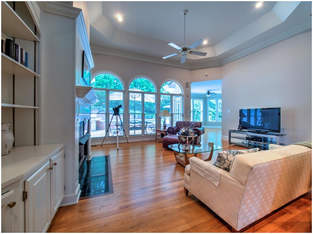 Soaring Trey Ceiling and Wall of Windows in Family Room