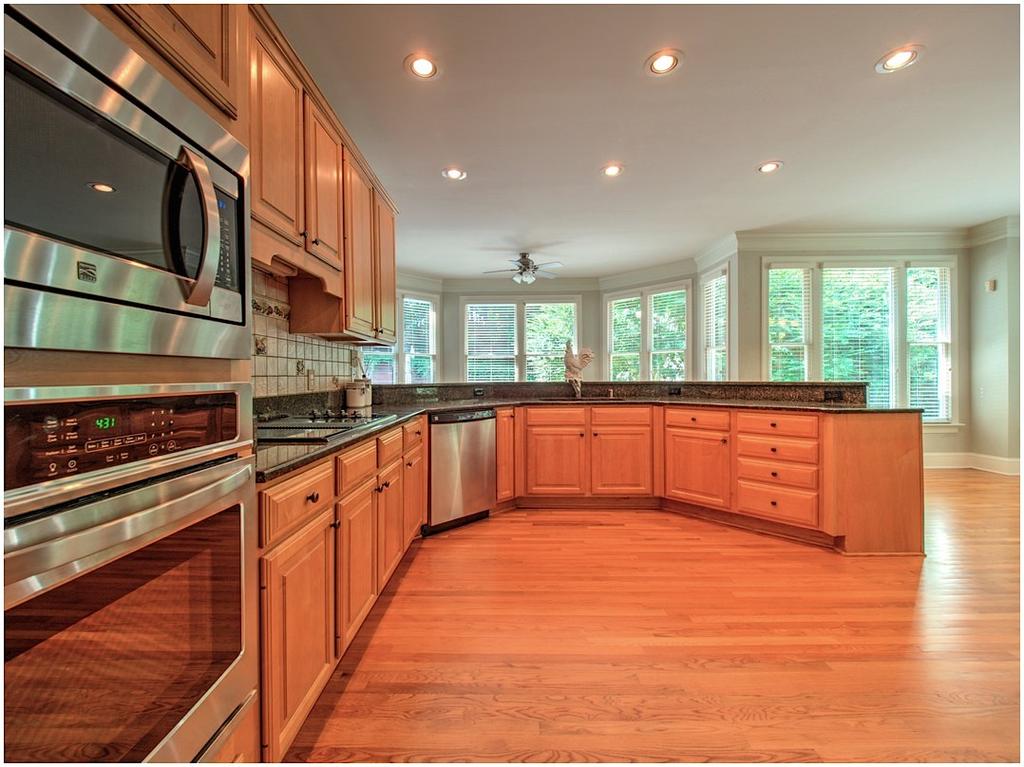 Breakfast Bar and Wall of Windows to Backyard Oasis