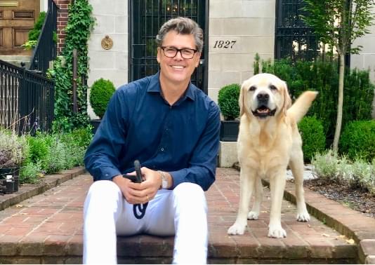 Jeff with happy labrador retriever named Hero