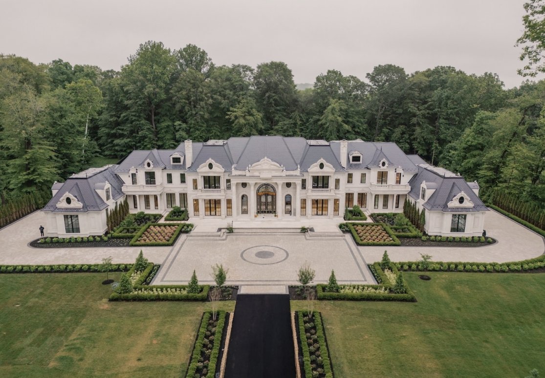 A stone manor illuminated at night