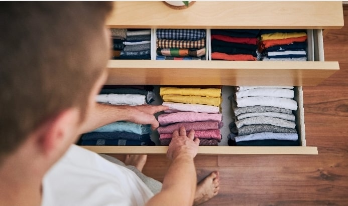 A man folding his shirts