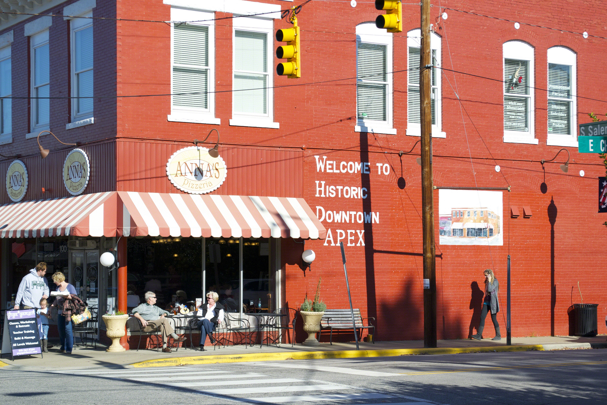 Old brick building with white lettering that reads "Historic Downtown Apex"