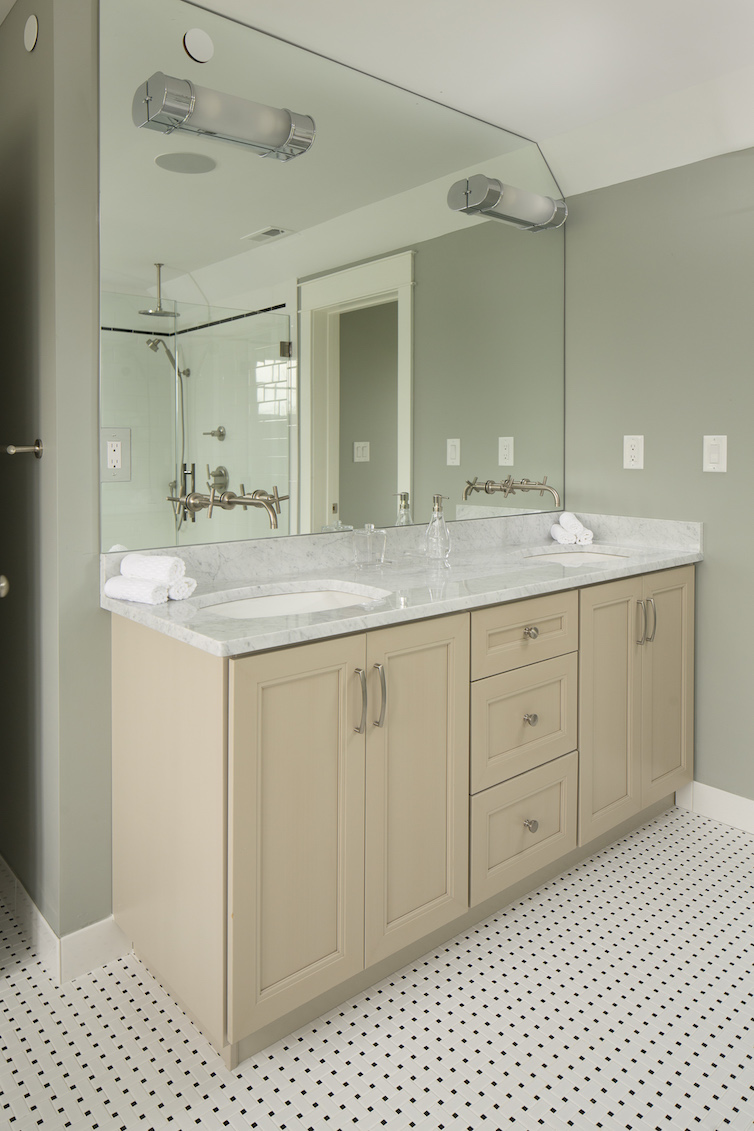 Bathroom counter with granite top and light wood base