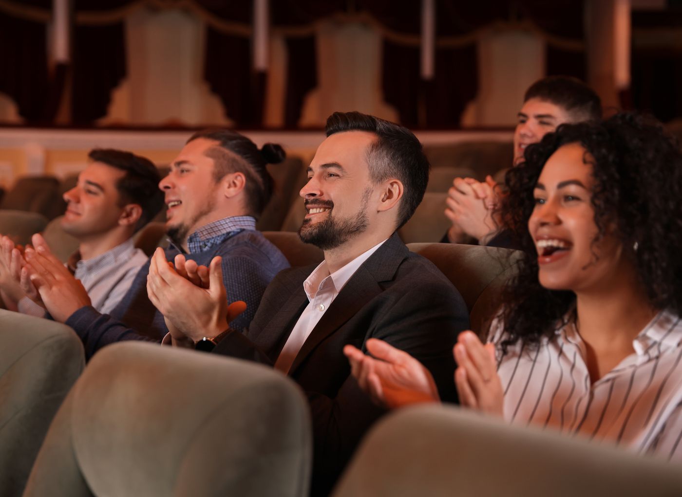 Theatre audience applauding during a live performance