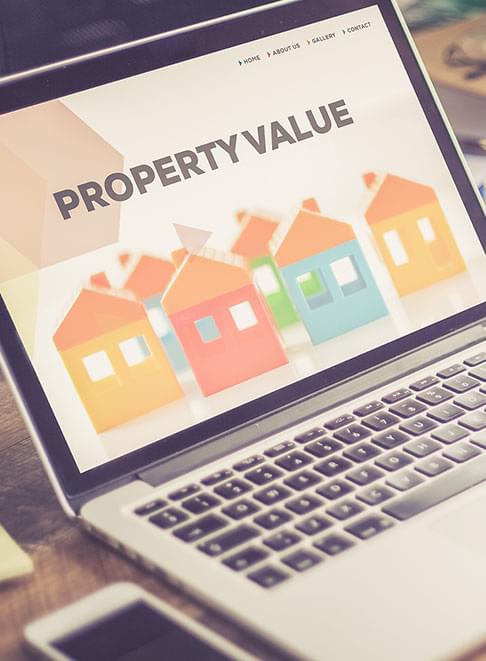 Laptop with property value webpage open